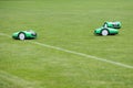 Automatic robotic lawnmower on green grass in the stadium