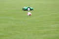 Automatic robotic lawnmower on green grass in the stadium