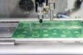 The automatic robotic operation in the circuit print board assembly line. Royalty Free Stock Photo