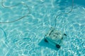 Robotic pool vacuum cleaner under water cleaning the floor