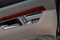 Automatic seat memory buttons on the passenger door panel upholstered in beige light natural leather with a wood element in the Royalty Free Stock Photo