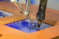 The automatic soldering machine operation with PCB board Royalty Free Stock Photo