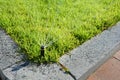 Automatic Sprinkler head spraying water over green grass. Royalty Free Stock Photo