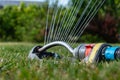 Automatic sprinkler system watering the lawn on a background of green grass Royalty Free Stock Photo