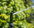 Automatic sprinklers watering grass. Garden Watering Systems. Irrigation System Watering the green grass Royalty Free Stock Photo
