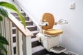 Automatic stair lift on staircase taking people Royalty Free Stock Photo