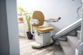 Automatic stair lift on staircase taking people Royalty Free Stock Photo