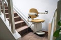 Automatic stair lift on staircase taking people Royalty Free Stock Photo