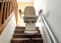 Automatic stair lift on staircase taking elderly Royalty Free Stock Photo