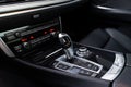 Automatic transmission and gear stick, electronic dashboard and black leather seats inside expensive auto. Premium car Royalty Free Stock Photo