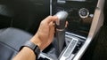 Automatic transmission handle, An Asian man's hand is holding the automatic transmission lever Royalty Free Stock Photo