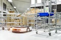 Automatic warehouse robot car carries cardboard box assembly in factory Royalty Free Stock Photo