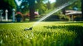 Automatic watering of the green lawn. The nozzle sprays water onto the lawn. Automatic lawn care