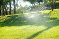 automatic watering system and water sprayed from the sprinkler for lawn, grass Royalty Free Stock Photo