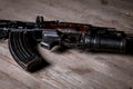 Automatic weapons kalashnikov assault rifle on wooden background. close up view Royalty Free Stock Photo