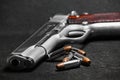 Automatic white gun stainless steel pistol weapon model m1911 with real bullet ammo head in black background