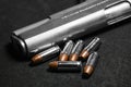 Automatic white gun stainless steel pistol weapon model m1911 with real bullet ammo head in black background