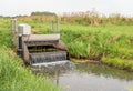 Automatic working small weir controls the water in a Dutch polder Royalty Free Stock Photo