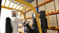 Automation warehouse with robot driving forklift