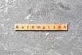 Automation word written on wood block. Automation text on cement table for your desing, concept