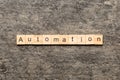 Automation word written on wood block. Automation text on cement table for your desing, concept