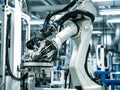 automative factory, a robotics arm with a milling spindle attachment performs the finishing cut on precision-engineered aluminum Royalty Free Stock Photo