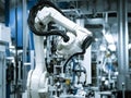 automative factory, a robotics arm with a milling spindle attachment performs the finishing cut on precision-engineered aluminum Royalty Free Stock Photo