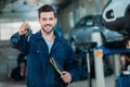 Automechanic holding car keys Royalty Free Stock Photo