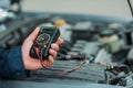Automechanic using digital multimeter Royalty Free Stock Photo