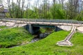 Automobile bridge over a stream with a drain Royalty Free Stock Photo