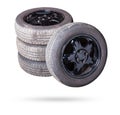 Automobile composition made up stack of tires and wheel with shiny black disc in the foreground against the background of cars in Royalty Free Stock Photo