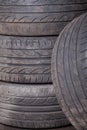 Automobile composition made up stack of tires and wheel with shiny disc in a car service before seasonal replacement or after