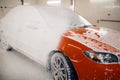 Automobile in foam, car wash service concept