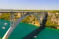 Automobile long high arched bridge over the Krka river in Croatia near Sibenik. Picturesque Croatian river landscape in Royalty Free Stock Photo