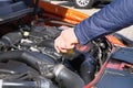 Automobile maintenance concept. Driver checking oil level in car engine. Cars and transportation, close up Royalty Free Stock Photo