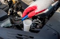 Automobile Maintenance. Filling the Windshield Washer Fluid on a Car Royalty Free Stock Photo