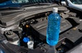 Automobile Maintenance. Filling the Windshield Washer Fluid on a Car Royalty Free Stock Photo