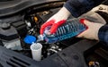 Automobile Maintenance. Filling the Windshield Washer Fluid on a Car Royalty Free Stock Photo