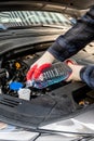 Automobile Maintenance. Filling the Windshield Washer Fluid on a Car Royalty Free Stock Photo