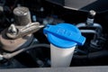 Automobile Maintenance. Windshield washer fluid cap with blue color in the engine room of car Royalty Free Stock Photo