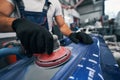 Repair shop worker sanding car with grinding machine Royalty Free Stock Photo