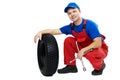 Automobile mechanic with car tire and spanner