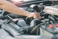 Automobile mechanic repairman hands repairing a car engine automotive workshop