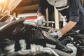 Automobile mechanic repairman hands repairing a car engine automotive workshop with a wrench, car service and maintenance,Repair