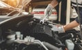 Automobile mechanic repairman hands repairing a car engine automotive workshop with a wrench, car service and maintenance,Repair