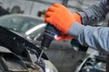 Automobile repair shop. Worker assembling car body