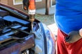 An automobile repairman assembles headlight on a car