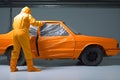 automobile repairman painter hand in protective glove with airbrush pulverizer painting car body in paint chamber