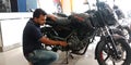 automobile sales staff presenting pulsar bike latest model into the bajaj showroom in India aug 2019