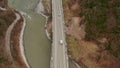 Automobile suspension bridge over the mountain river. Shooting from above using a drone